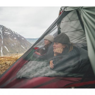 To personer kigger ud over fjeldlandskabet fra Robens Sprinter 2 LW telt med op­rullet oversejl.